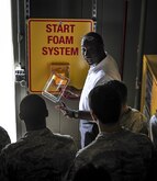 Jarvis Amos, 1st Special Operations Civil Engineer Squadron deputy fire chief, speaks with Airmen at Hurlburt Field, Fla., April 8, 2015. Hurlburt fire rescue men are capable of mitigating structural, aircraft and wildland fires, providing lifesaving emergency medical services and performing hazardous material mitigation and special operations such as trench, confined space and high and low angle rescue. (U.S. Air Force photo by Senior Airman Meagan Schutter)