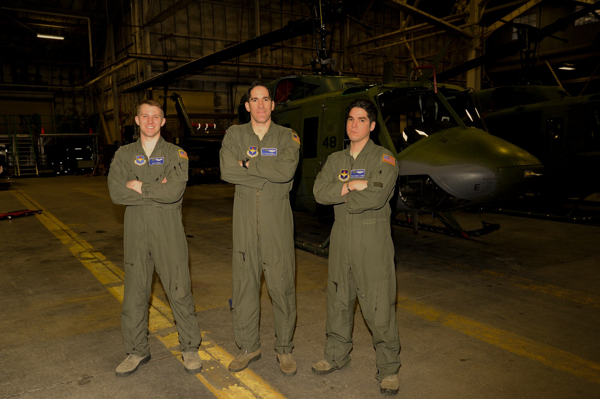 First Lt. Jeff Nixon, co-pilot, Maj. R. Tyler Rennell, aircraft commander, and Tech. Sgt. Andres Ponce, special mission aviator, all from the 36th Rescue Flight, pose with the UH-1N Iroquois helicopter, 69-6648, April 9, 2015, at Fairchild Air Force Base, Wash. This helicopter piloted by this flight crew flew the 17,000 flight hour milestone mission marking this helicopter as having the most flight hours in the Air Force inventory for that airframe. (U.S. Air Force photo/Airman 1st Class Nicolo J. Daniello)