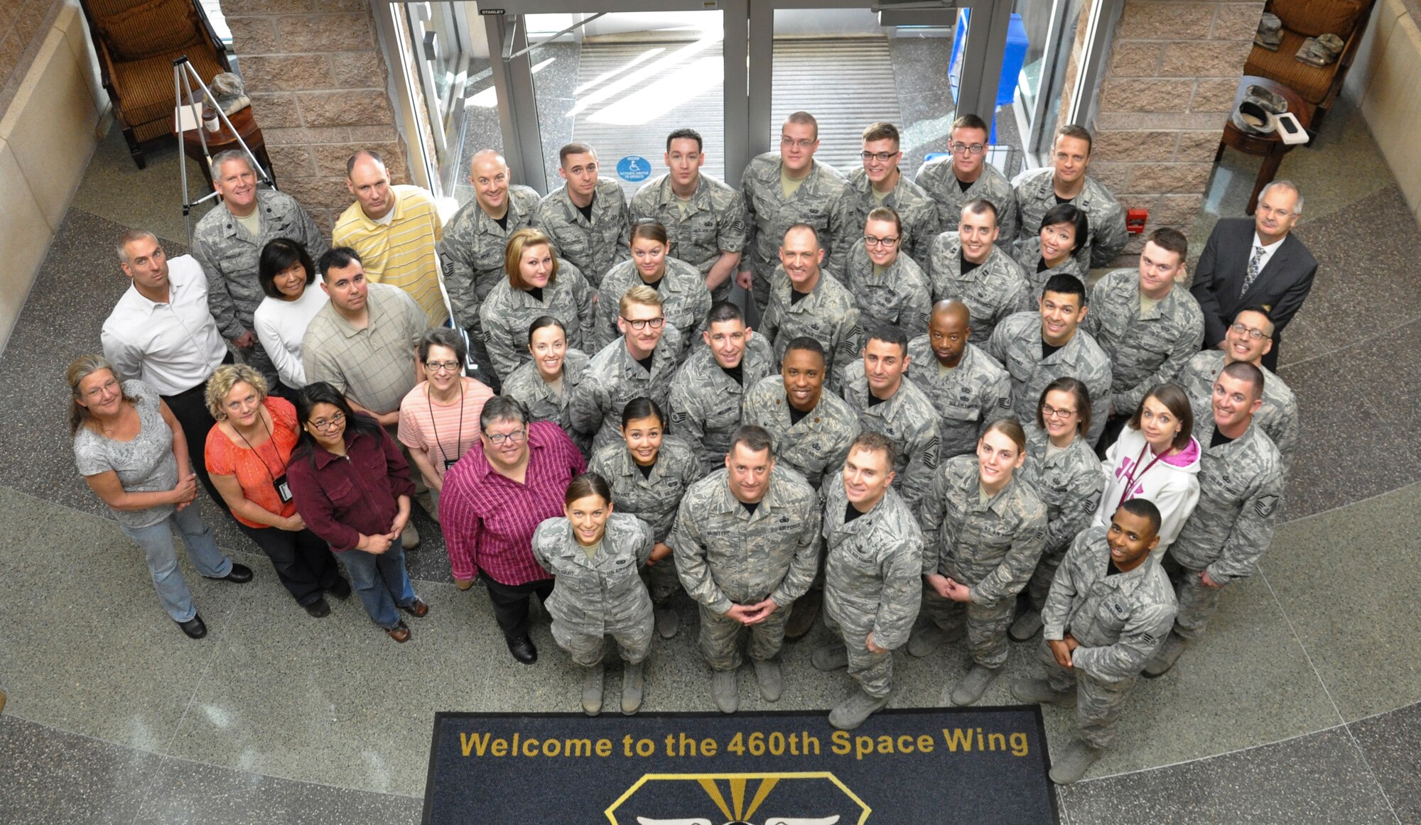 Chief Master Sgt. Douglas McIntyre, Air Force Space Command command chief, poses for a group photo with 460th Space Wing Airmen during his base visit April 9, 2015, on Buckley Air Force Base, Colo. During his visit, McIntyre spoke on Buckley AFB’s vast mission, its importance to national security, and the Airmen who accomplish the mission every day. (U.S. Air Force photo by Tech. Sgt. Nicholas Rau/Released)