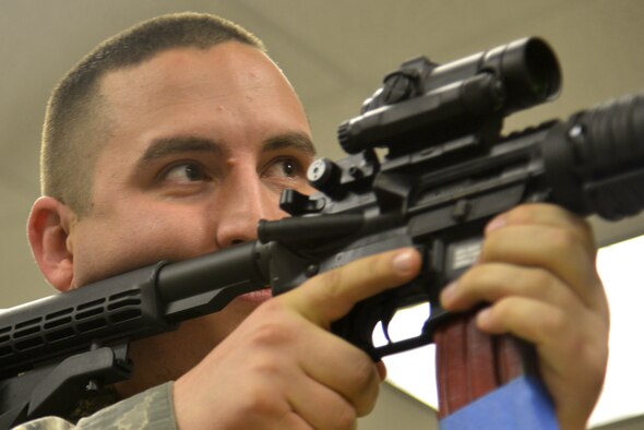 Senior Airman Kazimier Buryn, 92nd Communications Squadron network infrastructure technician, prepares to engage the M4 Carbine Assault Rifle during Operation M4 April 6, 2015, at Fairchild Air Force Base, Wash. Both Staff Sgts. Troy Tulleners and Shawn Robson, 92nd Security Forces Squadron combat arms instructors, trained and taught Airmen different procedures with the weapon. (U.S. Air Force photo/Senior Airman Janelle Patiño)