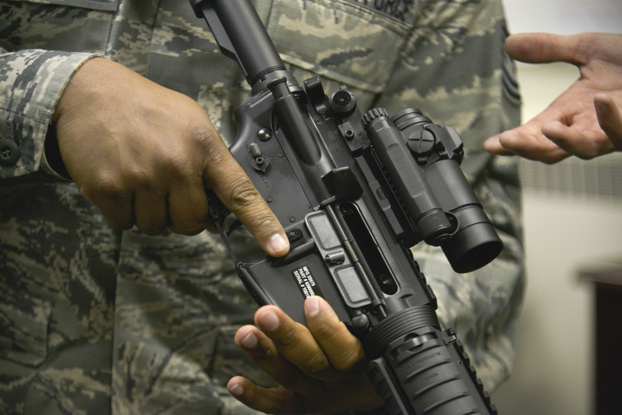 Tech. Sgt. Dwayne Harrell, 92nd Communications Squadron unit deployment manager, ensures the chamber of an M4 Carbine Assault Rifle is clear during Operation M4 April 6, 2015, at Fairchild Air Force Base, Wash. Combat arms instructors from the 92nd Security Forces Squadron accompanied  Chief Master Sgt. Christian Pugh, 92nd Air Refueling Squadron command chief, and other chief master sergeants to test Airmen's knowledge on how to use the weapon. (U.S. Air Force photo/Senior Airman Janelle Patiño)
