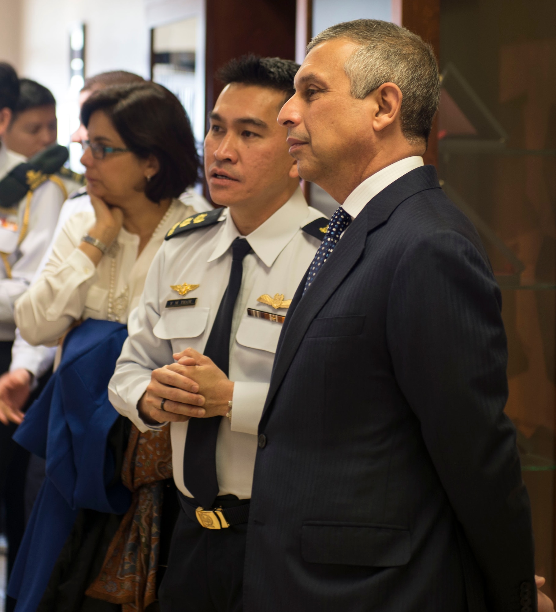 LTC Tham Yeow Min, PC V RSAF senior ranking officer and Ashok Kumar Mirpuri, Singapore Ambassador to the United States admire the history lining the walls of the 428th Fighter Squadron at Mountain Home Air Force Base, Idaho, April 9, 2015. The Ambassador visited the base to see the growing partnership between the United States and Singapore. (U.S. Air Force photo by Airman 1st Class Jessica H. Smith/RELEASED)