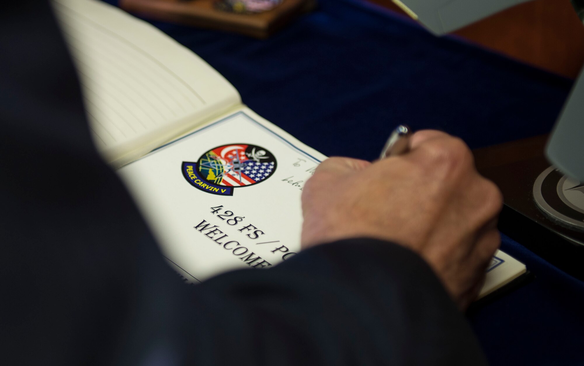 The Singapore Ambassador, Ashok Kumar Mirpuri signs the distinguished visitor’s guestbook at the 428th Fighter Squadron, Mountain Home Air Force Base, Idaho, April 9, 2015. The Ambassador visited Idaho over the course of three days. (U.S. Air Force photo by Airman 1st Class Jessica H. Smith/RELEASED)