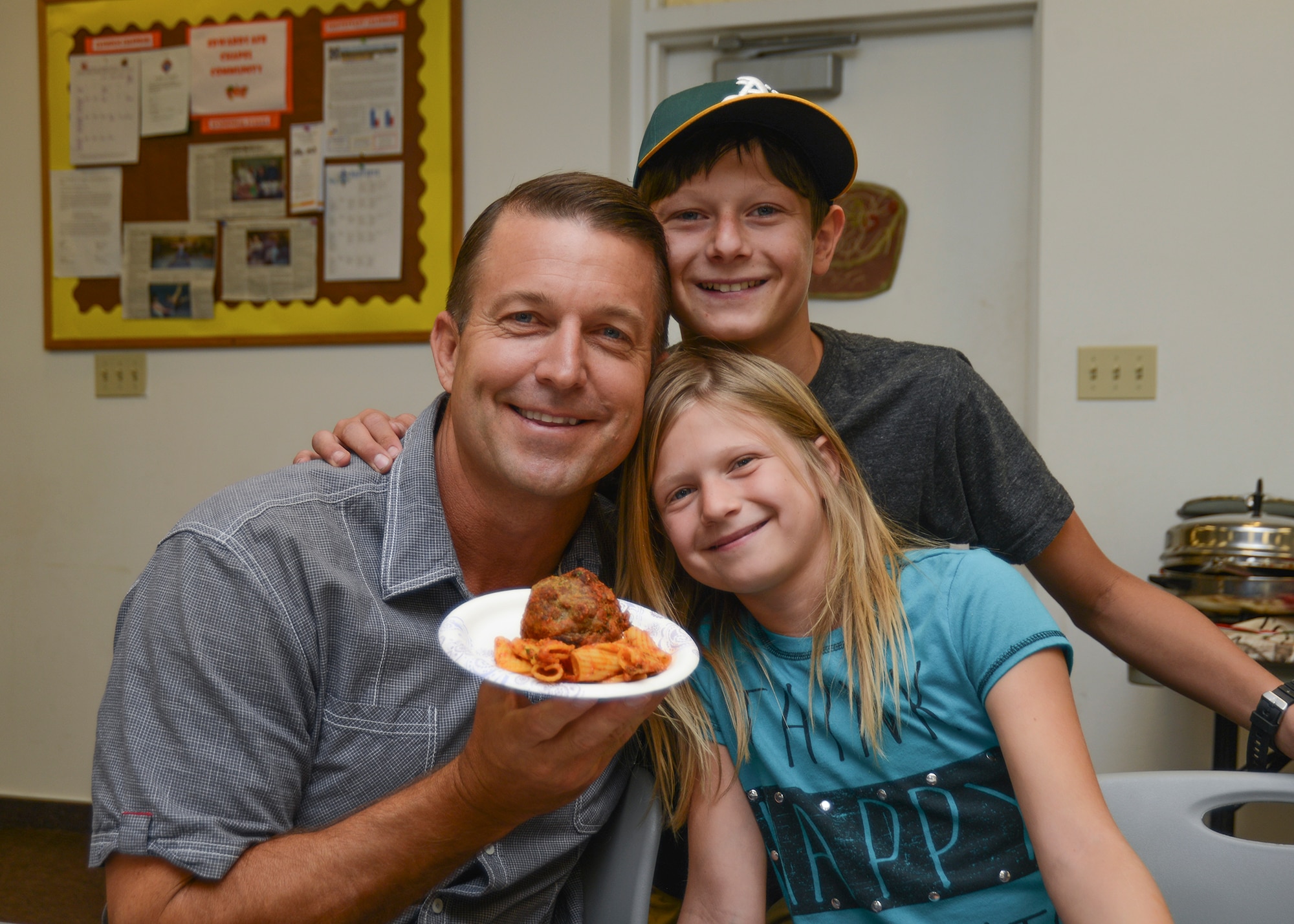 Col. Eric Leshinsky, 412th Mission Support Group commander, received first place for his "famous" two-pound spicy, stuffed mozzarella meatballs. He was accompanied by his children, Sophia and Benjamin at Family Advocacy's Top Pasta Chef competition to bring awareness to child abuse during National Child Abuse Prevention Month. (U.S. Air Force photo by Rebecca Amber)
