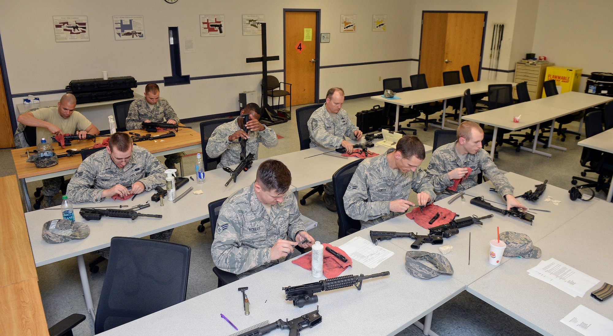 Airmen clean their weapons after a day of shooting at targets April 01, 2015, at McConnell Air Force Base, Kan. The Airmen learned the proper way to disassemble, reassemble, shoot and clean their weapons as a part of the Combat Arms Training and Maintenance class. (U.S. Air Force photo by Senior Airman Colby L. Hardin)