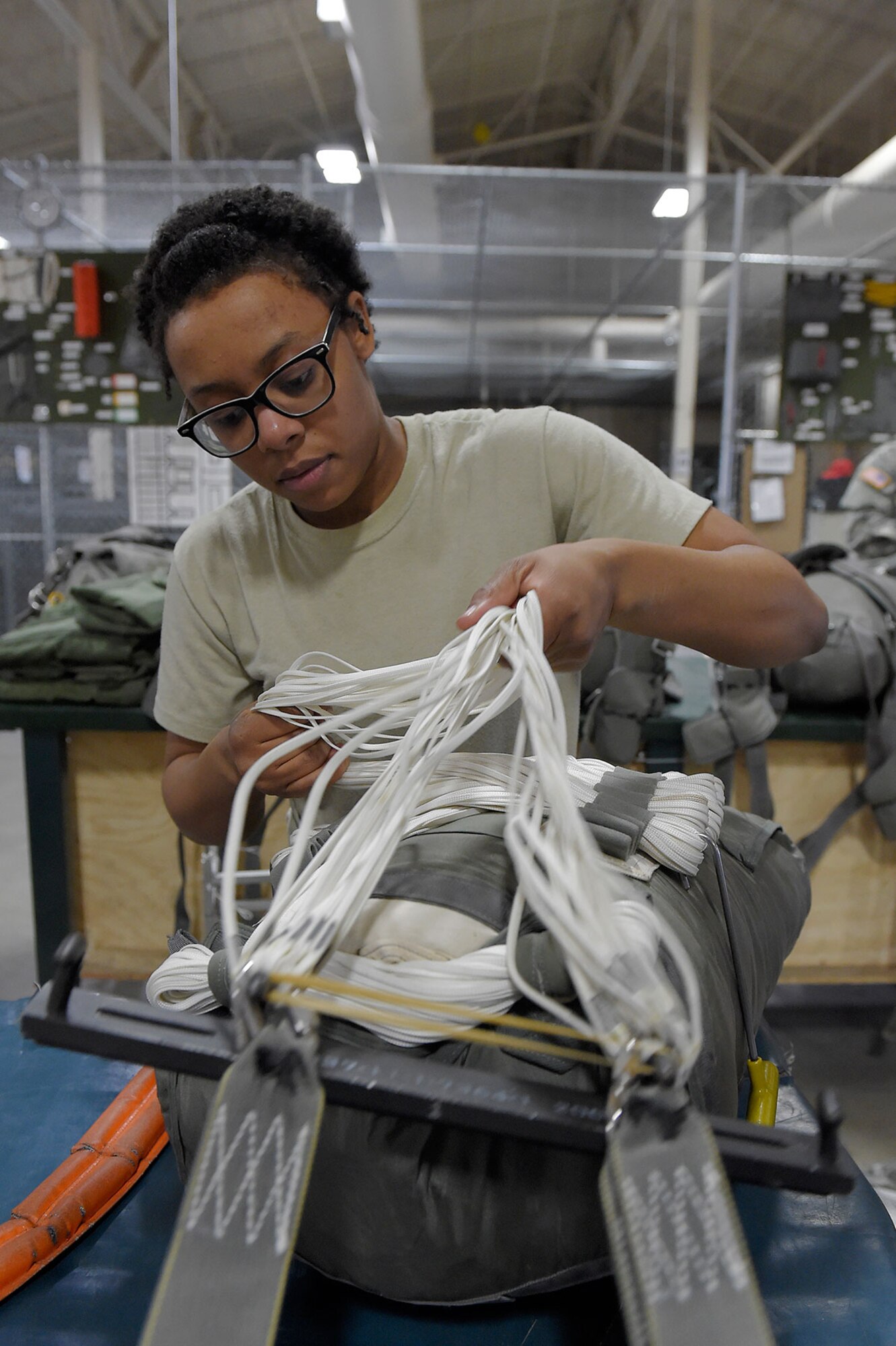 Spc. Brittany Williams, a native of Savannah, Ga., assigned to the 4th Quartermaster Company, 725 Brigade Support Battalion (Airborne), 4th Brigade Combat Team (Airborne), 25th Infantry Division, U.S. Army Alaska, packs a T-11 personnel parachute system on Joint Base Elmendorf-Richardson, Alaska, April 8, 2015. (U.S. Air Force photo/Alejandro Pena)




