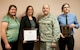(Left to right) Tracy Bogdanovich, 99th Medical Operations Squadron clinical research coordinator, Jill Clark, 99th MDOS clinical research manager, Lt. Col. Paul Crawford, 99th MDOS Clinical Investigation Program and Family Medicine Residency program director, and Aaron Barnett, 99th MDOS clinical research coordinator, pose for a photo at the Mike O’Callaghan Federal Medical Center on Nellis Air Force Base, Nev., April 6, 2015. The CIP was presented with the Association of Military Surgeons of the United States 2014 Training and Education Award and the FMR was presented with the 2015 Outstanding Achievement in Scholarly Activity Award by the Uniformed Services Academy of Family Physicians. (U.S. Air Force photo by Airman 1st Class Mikaley Towle)