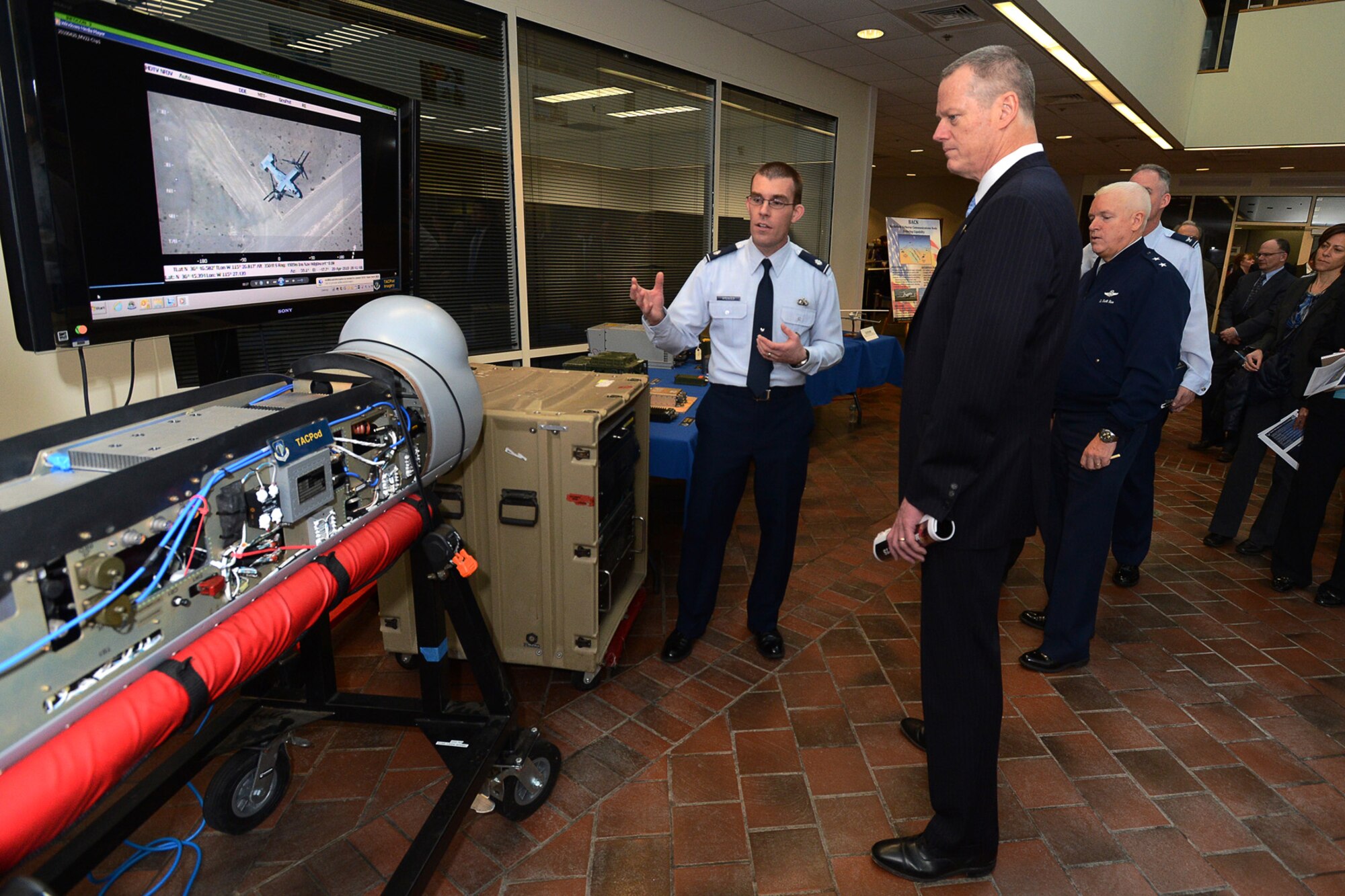 Lt. Col. Guy Spencer, Communication Systems Quick Reaction Capabilities Branch chief, briefs Mass. Governor Charlie Baker and Maj. Gen. L. Scott Rice, Mass. adjutant general, during the governor's visit to Hanscom Air Force Base April 10. The governor also saw program demonstrations and received briefings from each of the program executive officers and the base commander. (U.S. Air Force photo by Mark Herlihy)