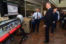 Lt. Col. Guy Spencer, Communication Systems Quick Reaction Capabilities Branch chief, briefs Mass. Governor Charlie Baker and Maj. Gen. L. Scott Rice, Mass. adjutant general, during the governor's visit to Hanscom Air Force Base April 10. The governor also saw program demonstrations and received briefings from each of the program executive officers and the base commander. (U.S. Air Force photo by Mark Herlihy)