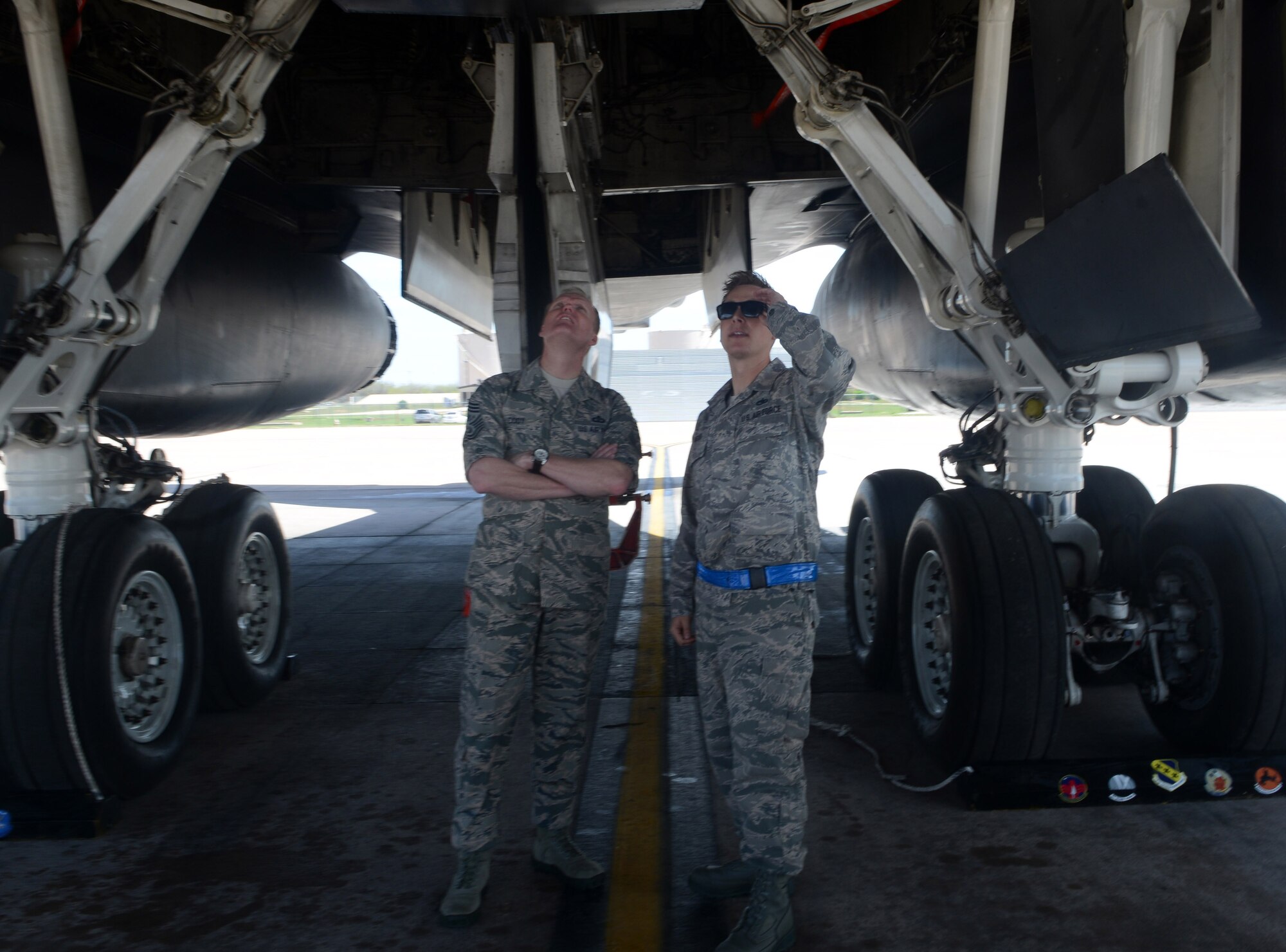 U.S. Air Force Chief Master Sgt. of the Air Force James A. Cody looks under a B-1B Lancer while receiving a tour from Tech Sgt. Kevin Meyer, 7th Aircraft Maintenance Squadron April 6, 2015, at Dyess Air Force Base, Texas. In addition to this tour, Cody received a brief on the accomplishments of the 9th Bomb Squadron and the capabilities of the B-1. (U.S. Air Force photo by Airman 1st Class Autumn Velez/Released)