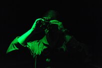 Lt. Col. Dan Roberts, 359th Aerospace Medicine Squadron Aerospace physiologist and night vision goggle advanced instructor, demonstrates how to focus night vision goggles during an NVG navigation course April 8, 2015 at Joint Base San Antonio-Randolph, Texas. Any students with Air Force specialties including enlisted aircrew, pararescue, remotely piloted aircraft, introduction to fighter fundamentals or pilot instructor training must first learn about human performance in airborne operations at the 359th Aerospace Medicine Squadron Aerospace and Operational Physiology Flight at JBSA-Randolph. A few tools used to train students include a Barany chair to help combat the motion sickness that comes with flying aircraft, an altitude chamber to familiarize students with hypoxia and a flight simulator for night vision goggle training. (U.S. Air Force photo by Joel Martinez/ Released)
