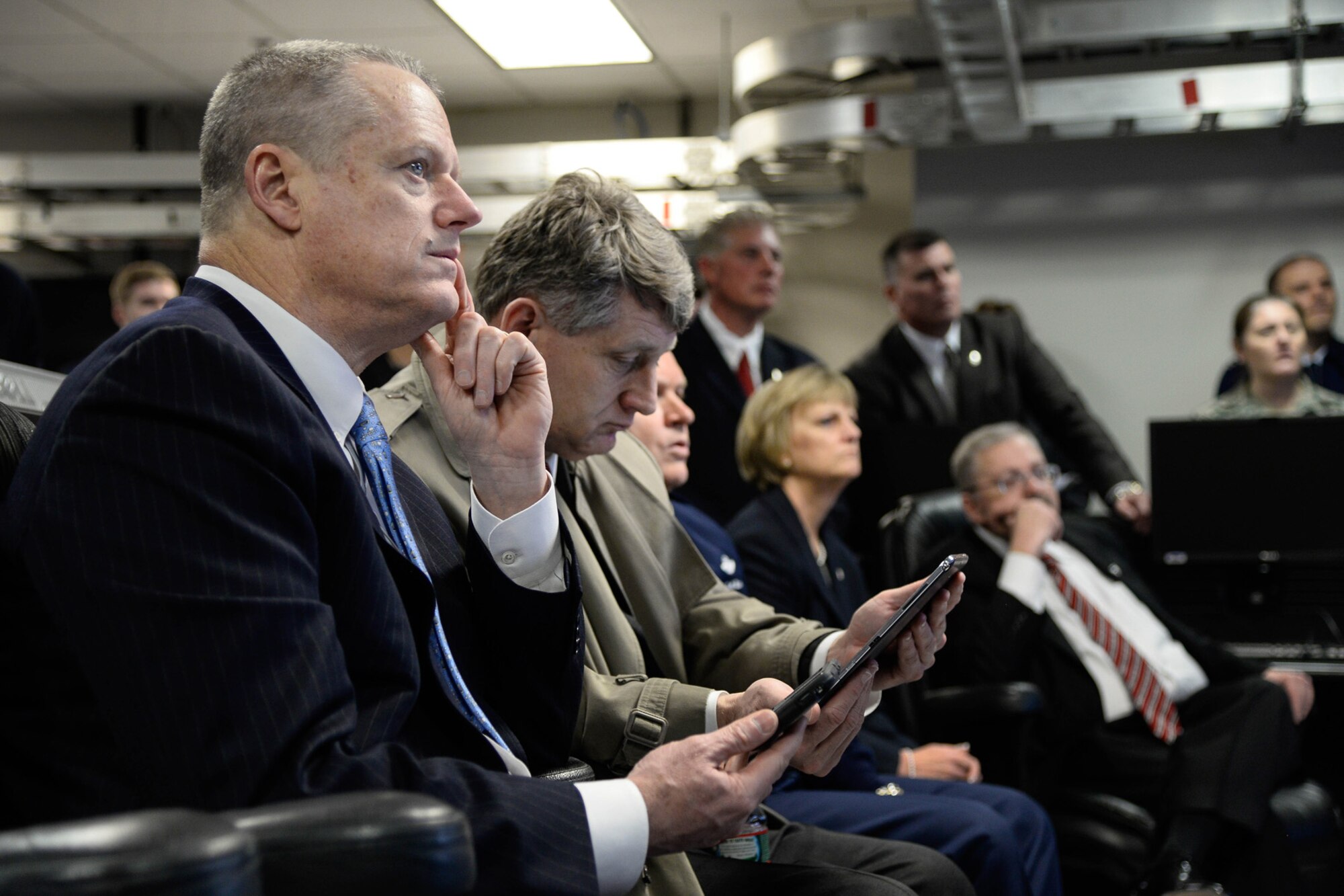 Mass. Governor Charlie Baker and Public Safety Secretary Daniel Bennett learn about how officials track real time emergencies through portable devices during a visit to the Hanscom Collaboration and Innovation Center April 10. The governor also saw program demonstrations and received briefings from each of the program executive officers and the base commander. (U.S. Air Force photo by Mark Herlihy)