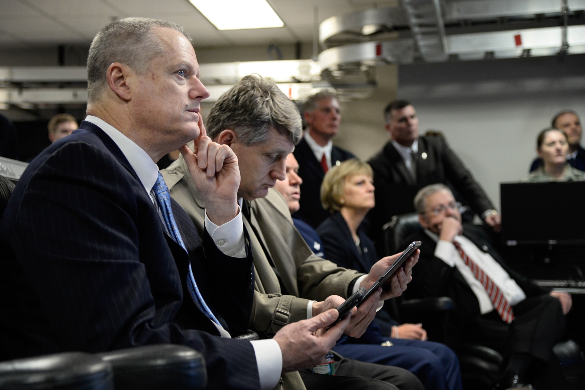 Mass. Governor Charlie Baker and Public Safety Secretary Daniel Bennett learn about how officials track real time emergencies through portable devices during a visit to the Hanscom Collaboration and Innovation Center April 10. The governor also saw program demonstrations and received briefings from each of the program executive officers and the base commander. (U.S. Air Force photo by Mark Herlihy)