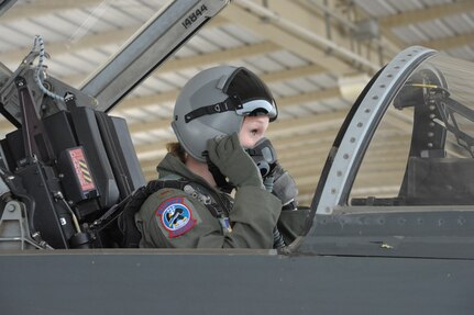 Second Lt. Kinder McCullough, 435th Fighter Training Squadron instructor pilot student, adjusts her mask and helmet during a pre-flight checklist before a training flight April 8, 2015 at Joint Base San Antonio-Randolph, Texas. The 435th Fighter Training Squadron, with a heritage that dates back to the World War II-era 435th Fighter Squadron, is the only unit at JBSA-Randolph that trains the Air Force’s newest aviators to become fighter pilots. The squadron’s two-fold mission is to forge up to 150 fighter pilots and weapon systems officers annually – including international students – and to mold experienced fighter pilots and WSOs into instructors for Air Education and Training Command’s Introduction to Fighter Fundamentals courses. (U.S. Air Force photo by Joel Martinez/ Released) 
