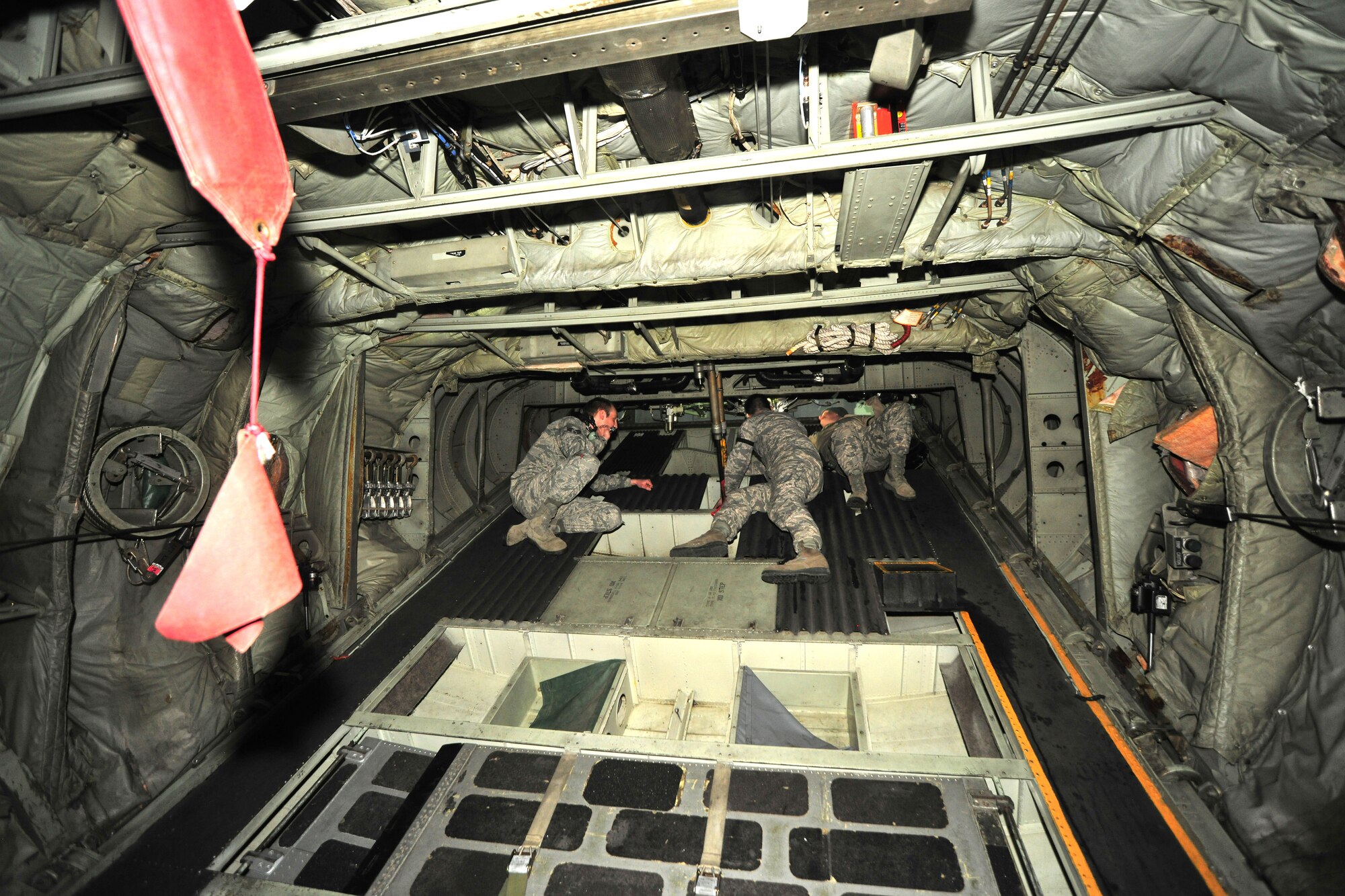 Three Airmen of the 166th Maintenance Squadron, Delaware Air National Guard at the New Castle ANG Base, Del., April 10, 2015, perform elevator boost pack maintenance on a C-130 Hercules transport aircraft. The aircraft will be flown April 11 during Operation Cyclone, a Delaware National Guard joint training exercise when Airmen and Soldiers will respond to a simulated tornado that has swept through New Castle County. Army Black Hawk helicopters will evacuate simulated wounded personnel to the air base, with patients loaded onto C-130s for aerial evacuation. Separate from the exercise, on April 12, six C-130s will participate in the largest formation flown by the wing since departing for Southwest Asia in March 2003 to support Operation Iraqi Freedom. (U.S. Air National Guard photo by Staff Sgt. John Michaels)