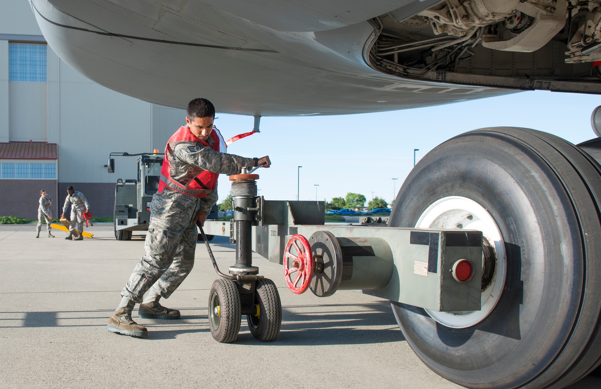 Staff Sgt. Garrett Garza, 60th Aircraft Maintenance Squadron lead crewchief for the April 3 C-5M Super Galaxy record-setting mission, connects a tow bar to move the aircraft from the hangar. Airmen from Travis Air Force Base, Calif., unofficially set 45 world records during the flight. Members of the base's maintenance and port operations were essential in making the record-setting attempt happen. (U.S. Air Force photo by Heide Couch)