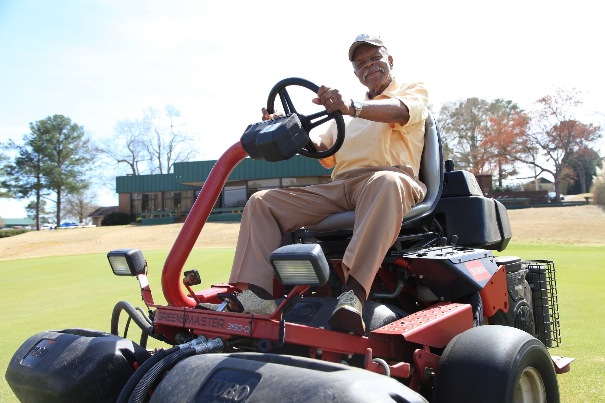 Robbie Robinson, 20th Force Support Squadron groundskeeper, operates a lawn mower at the Carolina Lakes Golf Course at Shaw Air Force Base, S.C., March 16, 2015. Robbie has been working on Shaw for 50 years, keeping up with the maintenance of the course. (U.S. Air Force photo by Derrick Rhems/Released)