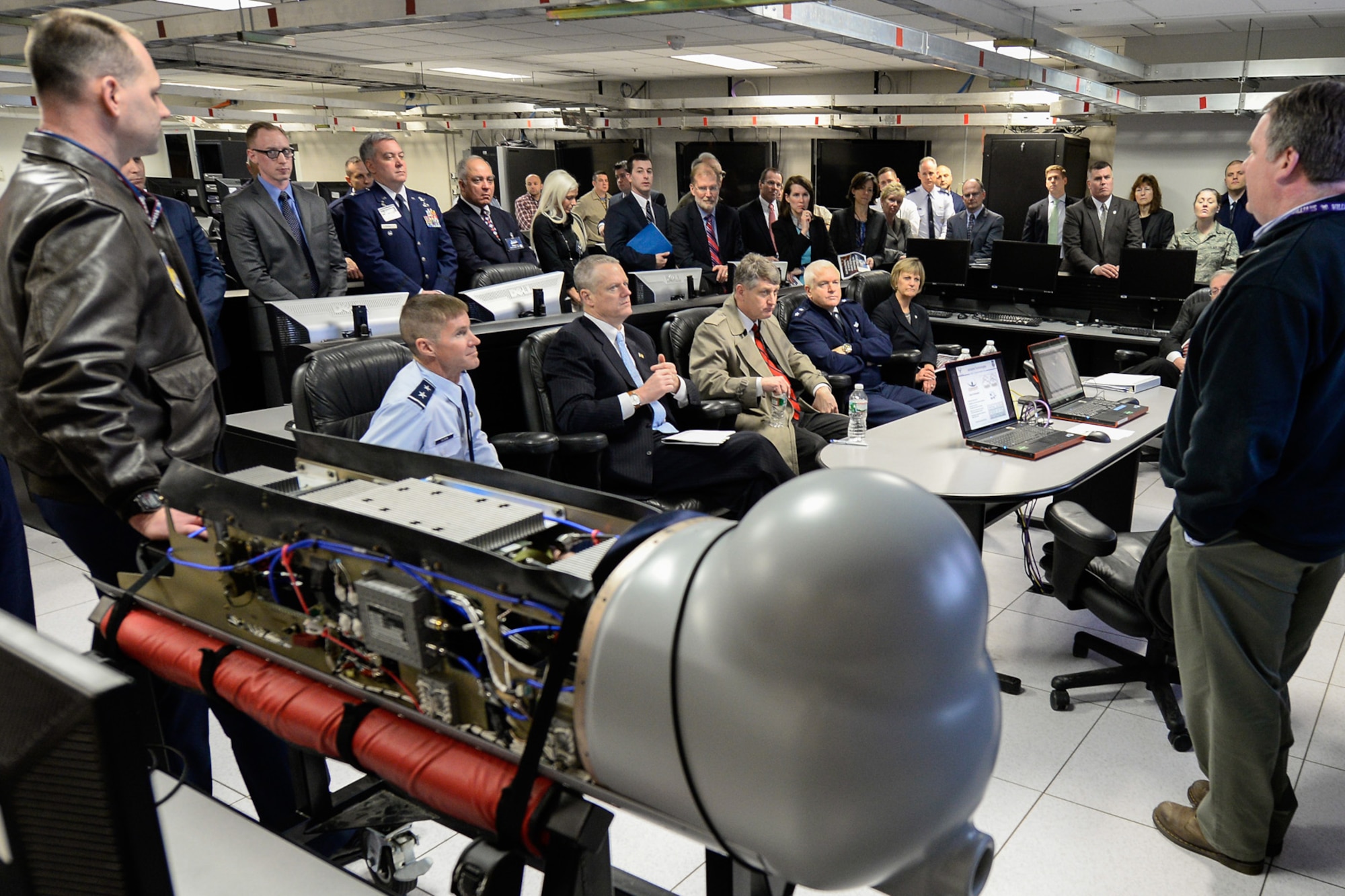 Peter Walsh of Jackpine Technologies briefs Mass. Governor Charlie Baker and Public Safety Secretary Daniel Bennett, along with other guests Maj. Gen. L. Scott Rice, Mass. adjutant general, and Patsy Reeves, Air Force Life Cycle Management Center executive director, during a visit to the Hanscom Collaboration and Innovation Center April 10. The governor also saw program demonstrations and received briefings from each of the program executive officers and the base commander. (U.S. Air Force photo by Mark Herlihy)