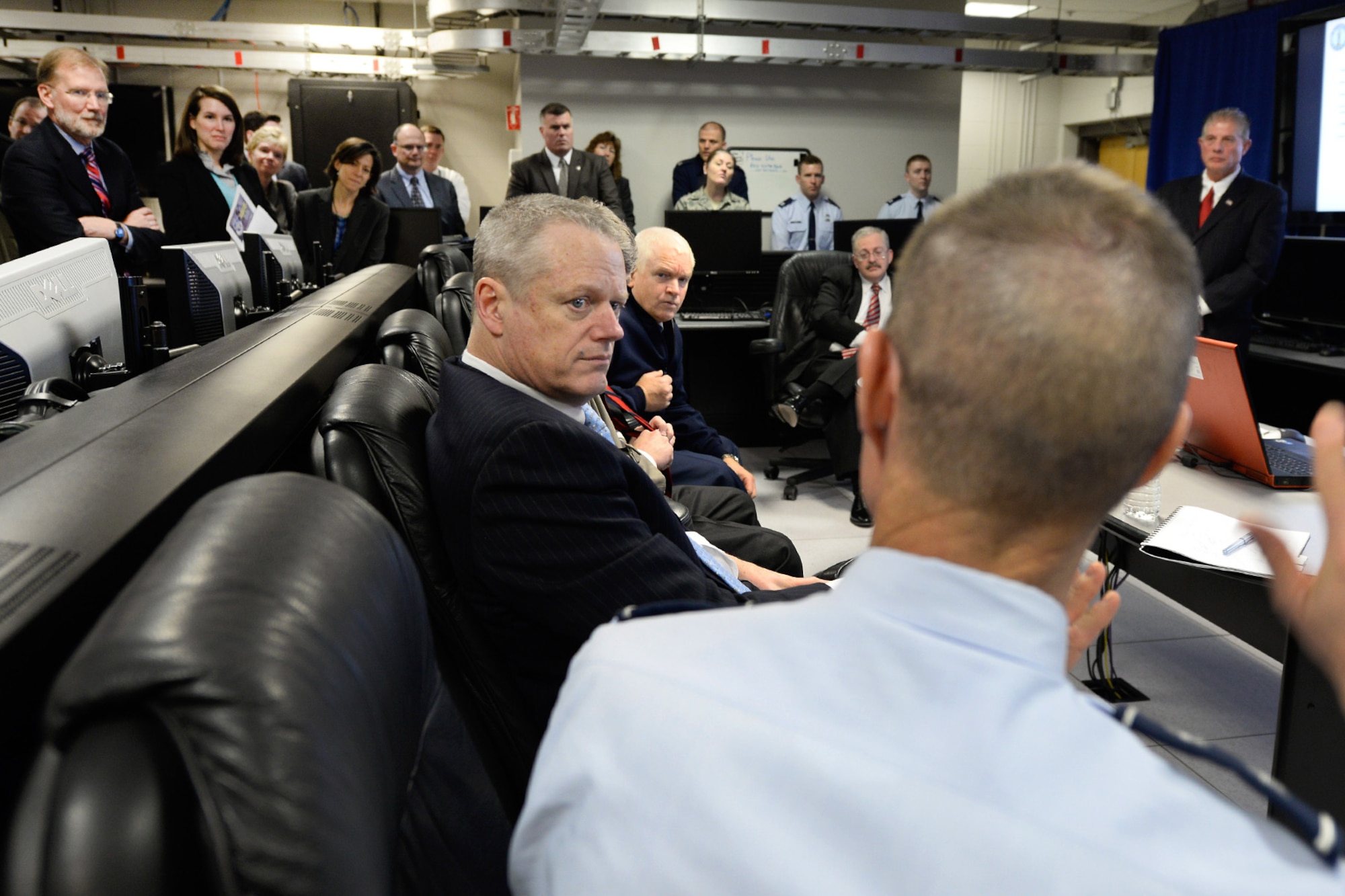 Mass. Governor Charlie Baker listens to Maj. Gen. Craig Olson, Command, Control, Communications, Intelligence Directorate program executive officer, during a visit to the Hanscom Collaboration and Innovation Center April 10. The governor also saw program demonstrations and received briefings from each of the program executive officers and the base commander. (U.S. Air Force photo by Mark Herlihy)
