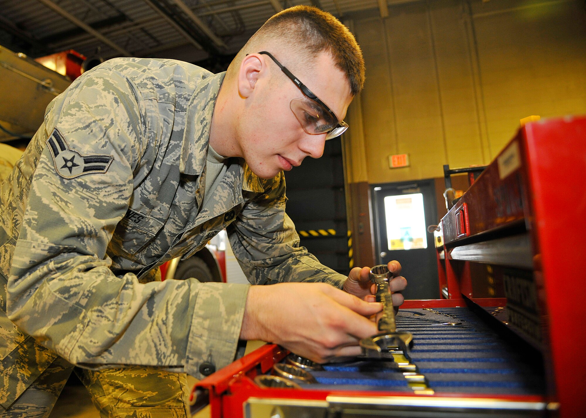 Airman 1st Class Tyler Jones, 319th Logistics Readiness Squadron vehicle maintenance apprentice, verifies the correct size wrench to use on April 8, 2015, on Grand Forks Air Force Base, N.D. Jones was selected as the Grand Forks AFB Warrior of the Week for the second week of April 2015. (U.S. Air Force photo by Senior Airman Xavier Navarro/Released)