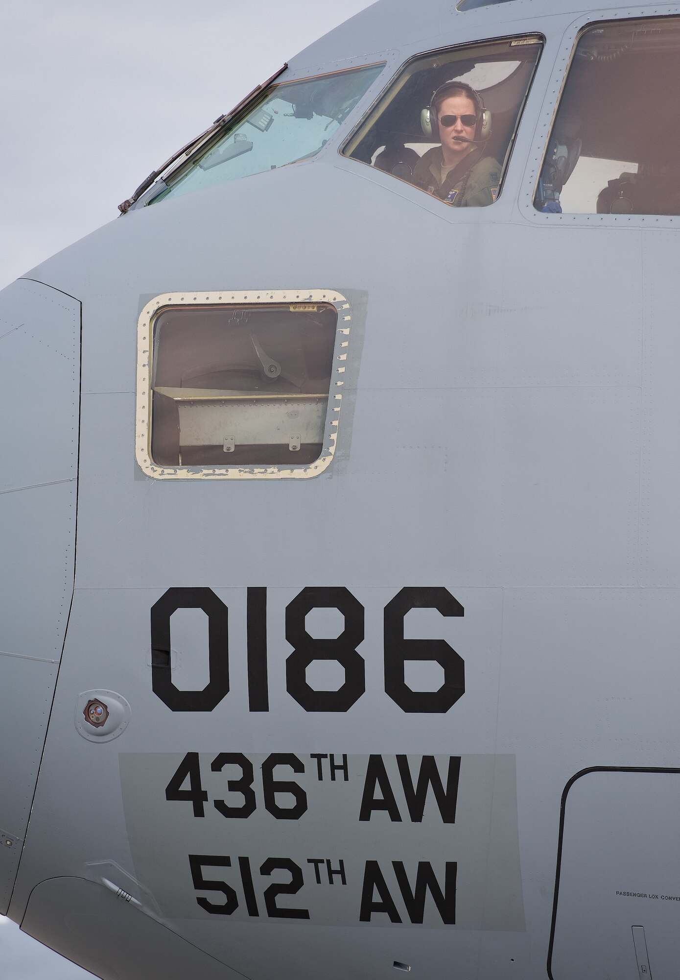 Capt. Erin Killion, 3d Airlift Squadron pilot, looks out the pilot's side window of a C-17 Globemaster III prior to engine start up March 25, 2015, at Dover AFB, Del. Killion, who is 15 weeks pregnant, was on this local training mission consisting of air refueling and short runway assault landings. (U.S. Air Force photo/Roland Balik)