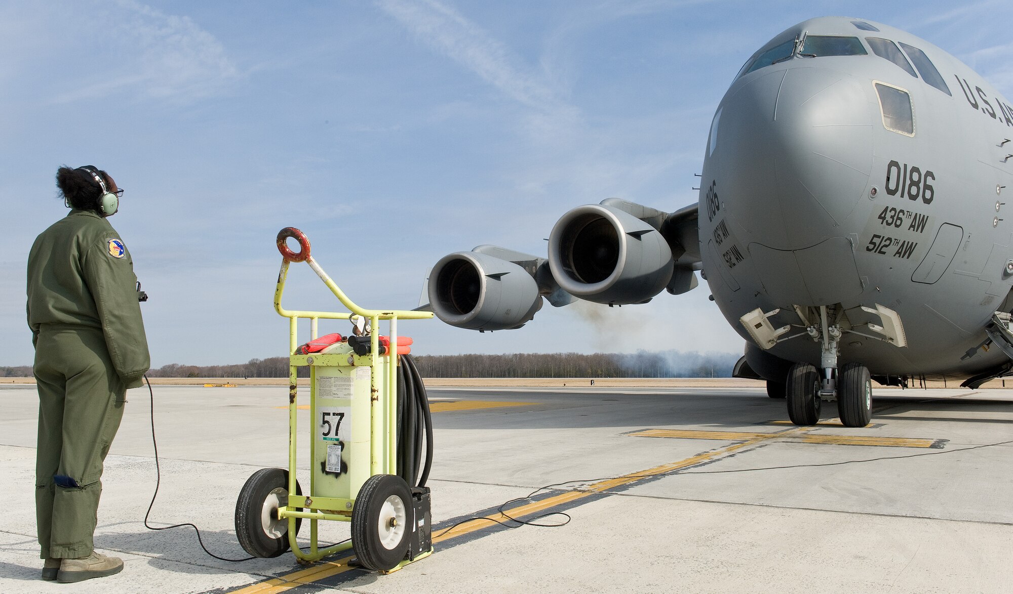 Senior Airman Tara Thorpe, 3d Airlift Squadron loadmaster, watches the C-17 Globemaster III number three engine start up March 25, 2015, on Dover AFB, Del. Thorpe was part of an all-female aircrew during a local training mission. (U.S. Air Force photo/Roland Balik)
