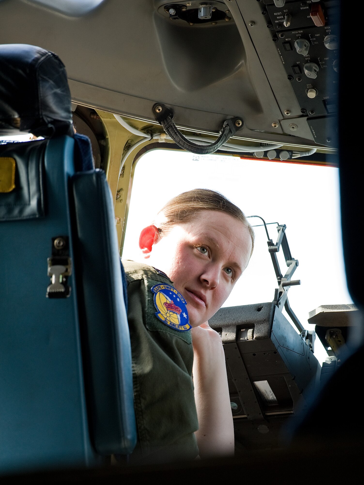 Capt. Erin Killion, 3d Airlift Squadron, listens to other aircrew members go over mission data March 25, 2015, at Dover AFB, Del. Killion, a C-17 Globemaster III pilot of three years, was on this local training mission to become recurrent as an aircraft commander. (U.S. Air Force photo/Roland Balik)
