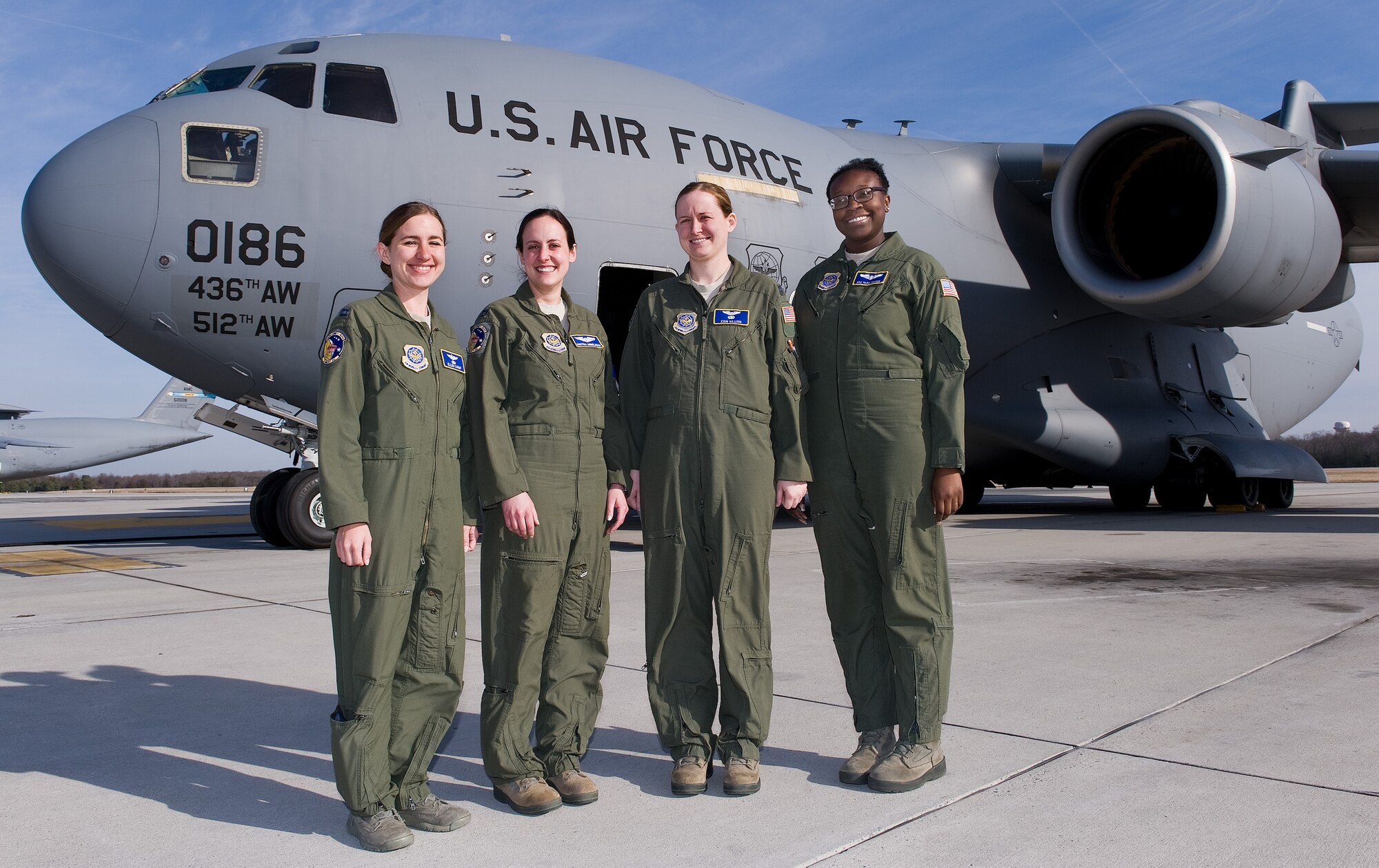 Capts. Ellen Canup, Kristina Himmelreich, Erin Killion, all pilots and Senior Airman Tara Thorpe, loadmaster, all from the 3d Airlift Squadron, pose for a photo prior departure March 25, 2015, at Dover AFB, Del. The all-female aircrew accomplished air refueling and short runaway assault landings during this local training mission. (U.S. Air Force photo/Roland Balik)
