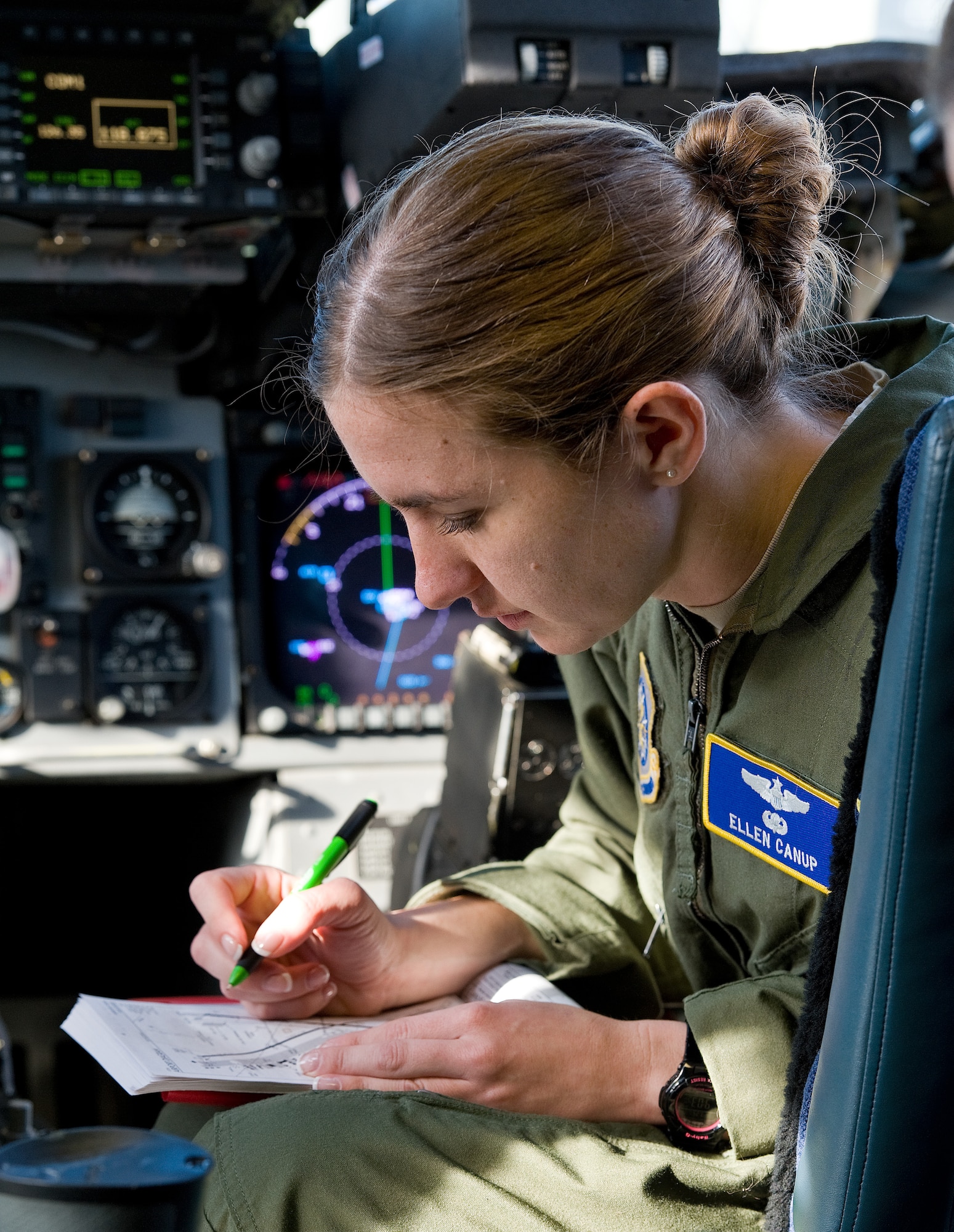 Capt. Ellen Canup, 3d Airlift Squadron instructor pilot, reviews an airfield diagram on the flight deck of a C-17 Globemaster III March 25, 2015, at Dover AFB, Del. Canup, with approximately 2,700 flying hours under her belt, assisted an aircraft commander get recurrent and another aircraft commander ready for instructor pilot upgrade training during a local training mission. (U.S. Air Force photo/Roland Balik)