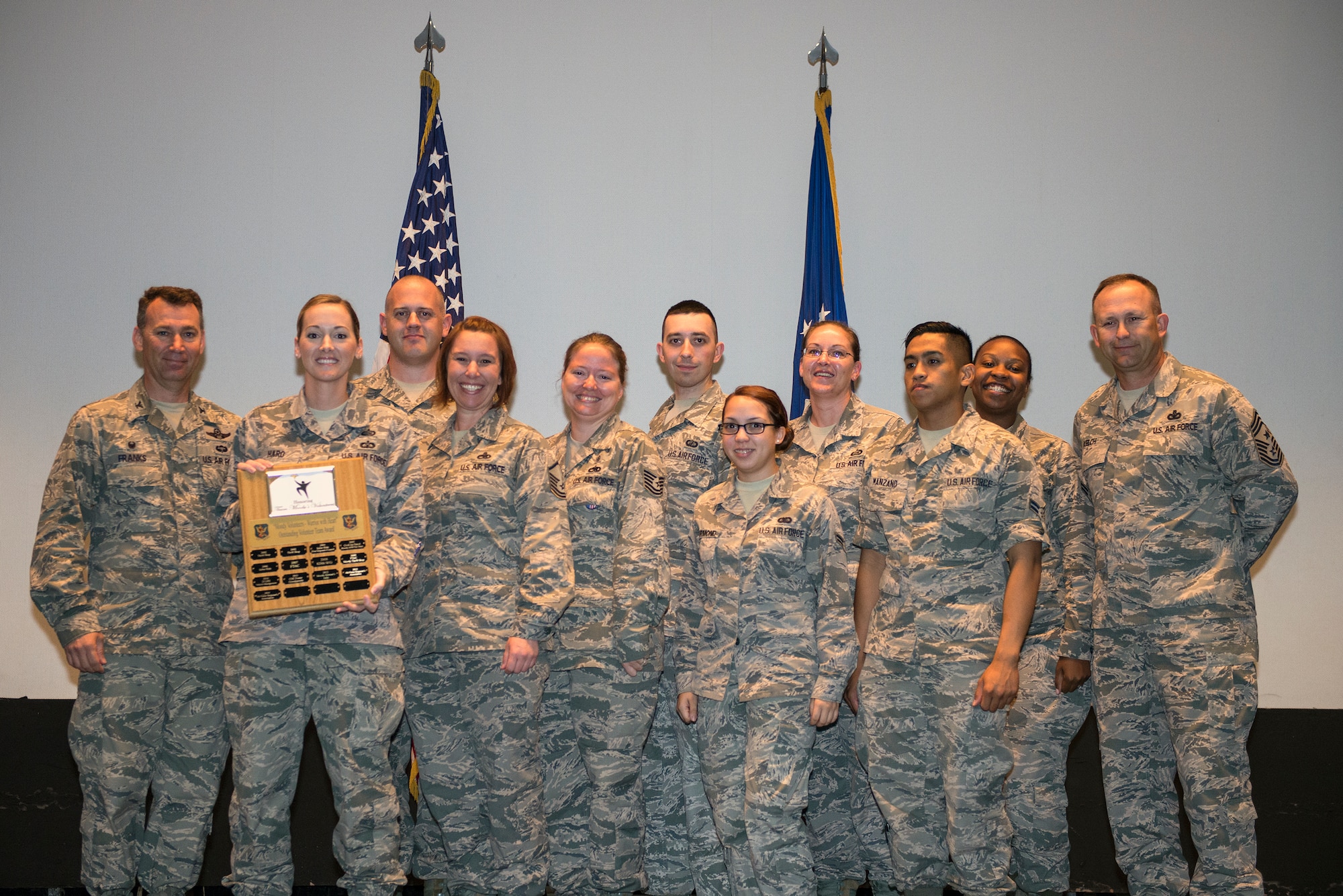 Members of the Air Force Sergeants Association Chapter 460 receive the Outstanding Team Award during the Volunteer Recognition Ceremony April 9, 2015, at Moody Air Force Base, Ga. The chapter volunteered over 8,000 hours while raising $150,000 for various local and national charities. (U.S. Air Force photo by Airman Greg Nash/Released)