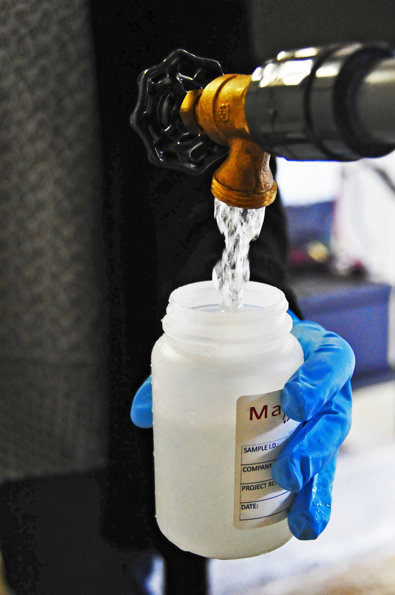 Kathy Levelier, the 354th Medical Operations Squadron bioenvironmental drinking wter program manager, fills a bottle with a water sample at Eielson Air Force Base, Alaska, April 7, 2015.  A water sample is collected at a potable drinking water well, processed and shipped to a certified analysis lab for testing.  (U.S. Air Force photo by Tech Sgt. Miguel Lara III/Released)