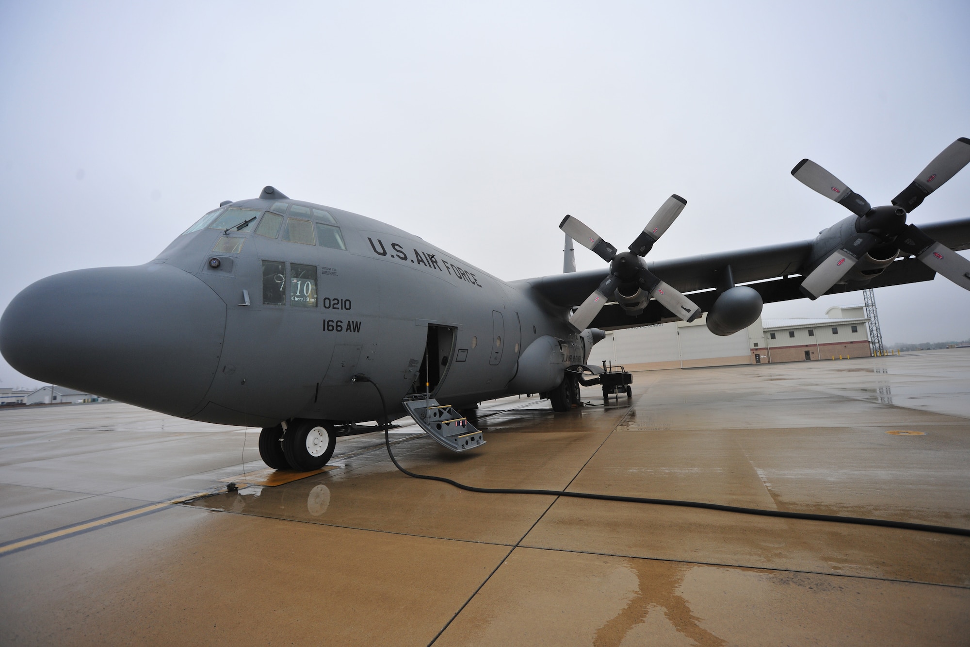 A C-130 Hercules transport aircraft of the 166th Airlift Wing, Delaware Air National Guard at the New Castle ANG Base, Del., April 10, 2015. The aircraft will be flown April 11 during Operation Cyclone, a Delaware National Guard joint training exercise when Airmen and Soldiers will respond to a simulated tornado that has swept through New Castle County. Army Black Hawk helicopters will evacuate simulated wounded personnel to the air base, with patients loaded onto C-130s for aerial evacuation. Separate from the exercise, on April 12, six C-130s will participate in the largest formation flown by the wing since departing for Southwest Asia in March 2003 to support Operation Iraqi Freedom. (U.S. Air National Guard photo by Staff Sgt. John Michaels)