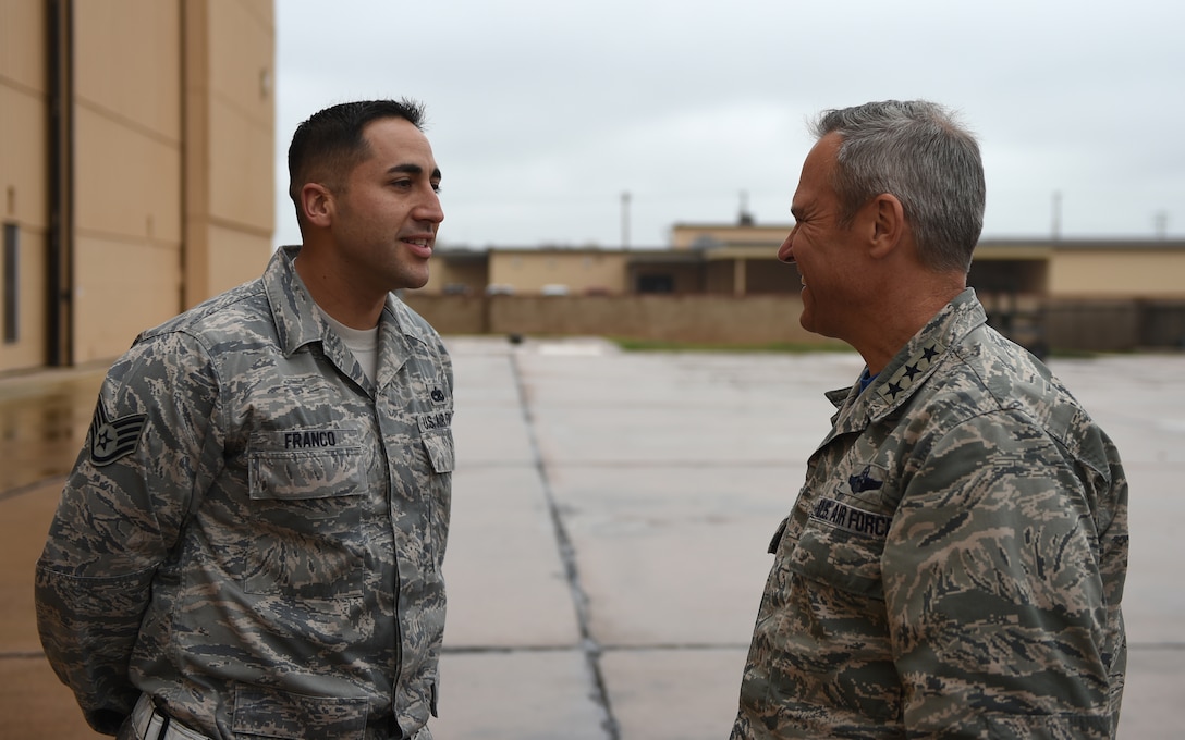 U.S. Air Force Staff Sgt. John H. Franco II, 7th Aircraft Maintenance Squadron, greets Lt. Gen. Chris Nowland, 12th Air Force commander, March 20, 2015, at Dyess Air Force Base, Texas. Nowland met with many Airmen while touring Dyess, some of which he recognized for their innovative efforts to streamline different parts of their respective jobs. Franco explained the new foreign object and debris walk method he helped develop to make flightline inspections more efficient.  (U.S. Air Force photo by Airman 1st Class Alexander Guerrero/Released) 