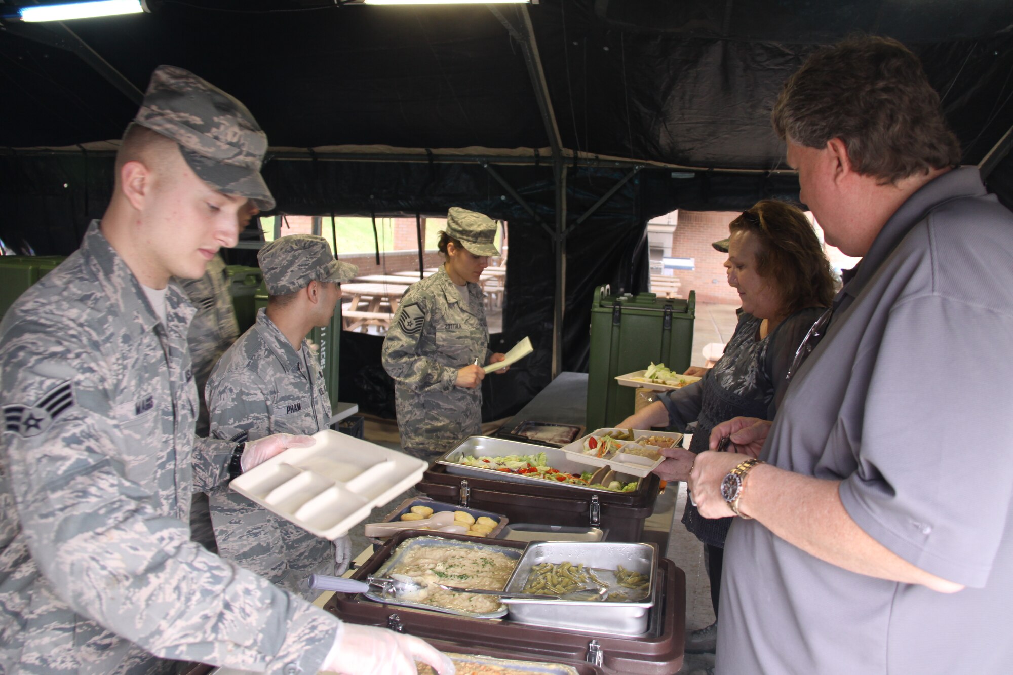 Members of the 911th Force Support’s Sustainment Flight take the opportunity to serve lunch out of the single-pallet expeditionary field kitchen, April 10, 2015 prior to an upcoming evaluation by the Hennessey Evaluation Team. (U.S. Air Force photo by Master Sgt. Mark A. Winklosky)