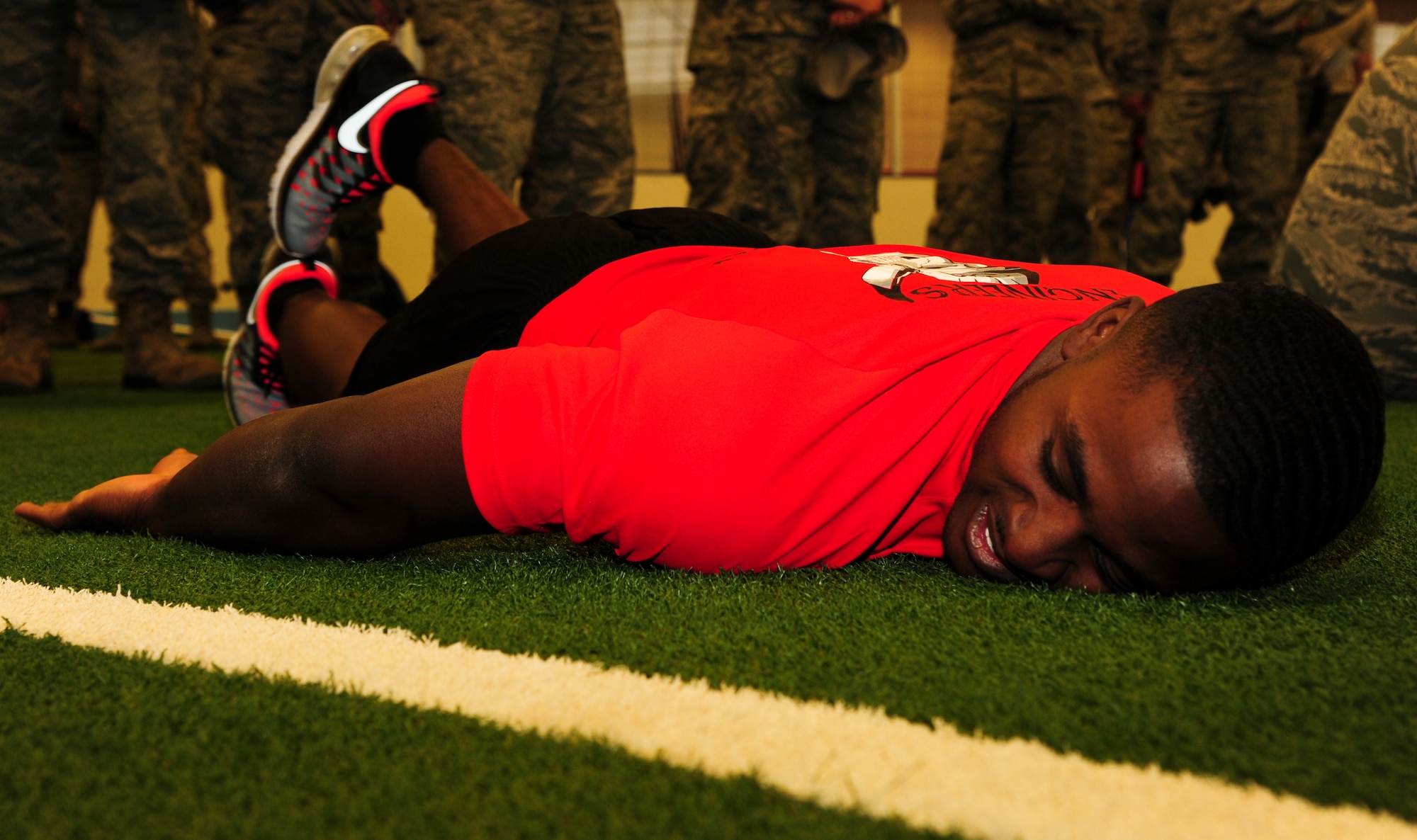 Senior Airman Reginald Roberts, 319th Civil Engineer Squadron electrical power production journeyman, lays exhausted during the 2015 Shirts’ Council Push Up-A-Thon April 9, 2015, at the Fitness Center on Grand Forks Air Force Base, N.D. Roberts completed more than 300 pushups at the Shirt’s Council Push Up-A-Thon. Competitors solicit pledges to help raise funds for the First Sergeants Council Operation Warm Heart, which provides charity and morale programs to GFAFB Airmen. (U.S. Air Force photo by Airman 1st Class Ryan Sparks/released)