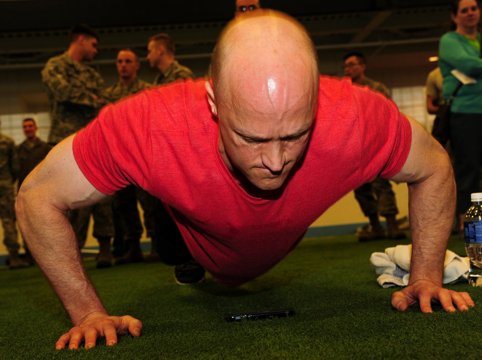 Col. Robert J. Cook, 319th Air Base Wing vice commander, muscles his way off the ground during the 2015 Shirts’ Council Push Up-A-Thon April 9, 2015, at the Fitness Center on Grand Forks Air Force Base, N.D. Cook was one of many competitors in the Shirt’s Council Push Up-A-Thon. Competitors solicit pledges to help raise funds for the First Sergeants Council Operation Warm Heart, which provides charity and morale programs to GFAFB Airmen.  (U.S. Air Force photo by Airman 1st Class Ryan Sparks/released)