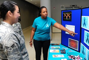 U.S. Air Force Staff Sgt. Antwina Ashmon, Langley Air Force Base Sexual Assault Prevention and Response victim advocate, right, talks about misconceptions and facts associated with sexual violence during the Sexual Assault Awareness Fair at the U.S. Air Force Hospital Langley atrium at Langley Air Force Base, Va., April 8, 2015. The SAPR office personnel will host a series of events to raise awareness throughout April across Joint Base Langley Eustis, Va. (U.S. Air Force photo by Staff Sgt. Natasha Stannard/Released) 

