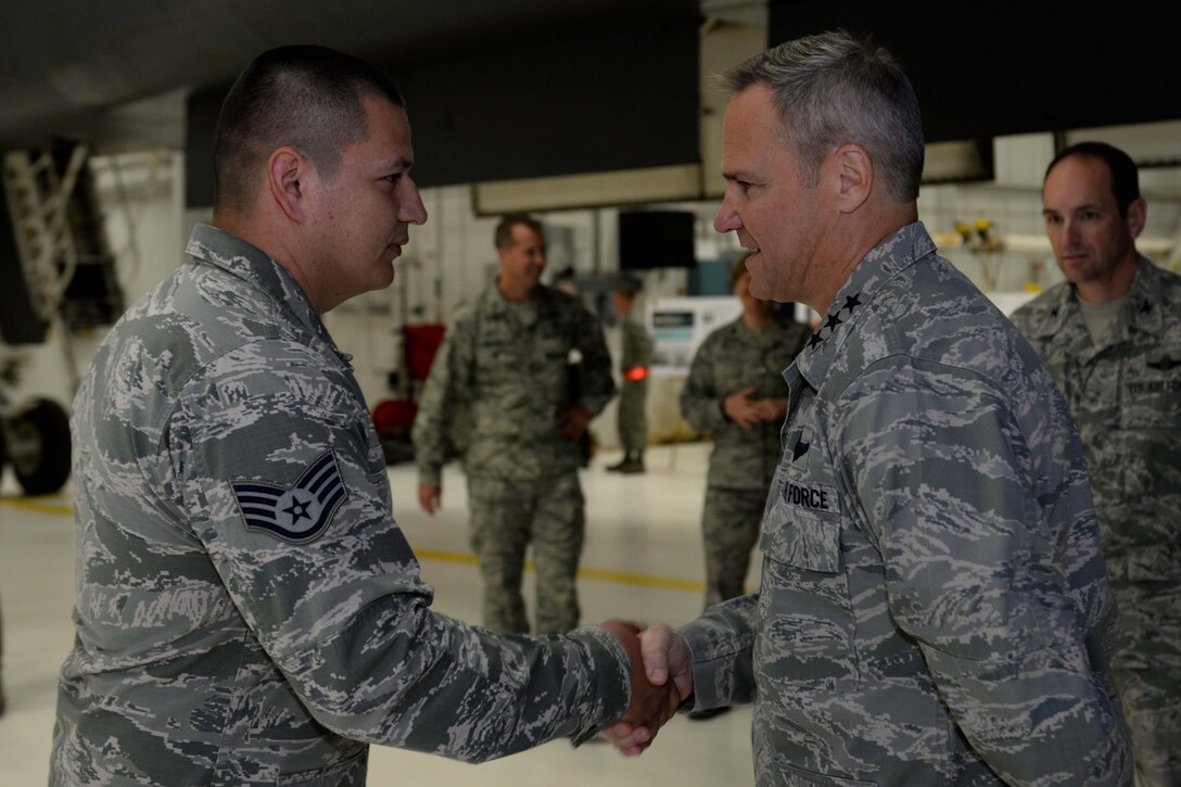 Lt. Gen. Chris Nowland, 12th Air Force commander, coins Staff Sgt. Kenneth Hill, 28th Bomb Wing ground safety technician, during his visit at Ellsworth Air Force Base, S.D., April 8. 2015. Nowland met with Airmen from multiple base agencies and witnessed first-hand how team Ellsworth accomplishes the mission. (U.S. Air Force photo by Airman 1st Class Rebecca Imwalle/Released)