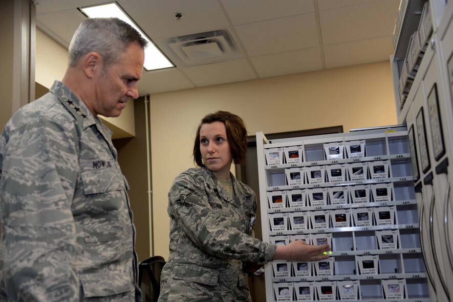 Airman Megan Cronin, 28th Medical Support Squadron pharmacy technician, explains the operations of a global script locator to Lt. Gen. Chris Nowland, 12th Air Force commander, during his visit at Ellsworth Air Force Base, S.D., April 8. 2015. The GSL is a medication storage system Ellsworth’s Pharmacy uses to accurately and effectively dispense patient prescriptions. (U.S. Air Force photo by Airman 1st Class Rebecca Imwalle/Released)