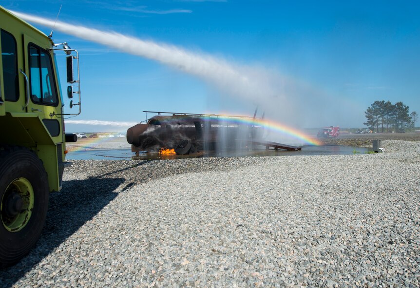 A P-23 fire truck douses flames with water during joint aircraft fire training April 8, 2015, at Moody Air Force Base, Ga. The truck holds 3,300 gallons of water and allows operators to extinguish the flames from inside the vehicle. (U.S. Air Force photo by Airman 1st Class Ceaira Tinsley/Released)