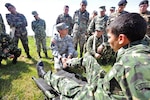 Staff Sgt. Robert Hogeland (center), the clinical operations NCO in charge at U.S. Army South’s medical directorate, demonstrates various ways to stabilize a fractured ankle to members of the Uruguayan military during a tactical Combat Lifesaver Course subject matter expert exchange in September 2014 outside of Montevideo, Uruguay.
Photo by Robert Ramon