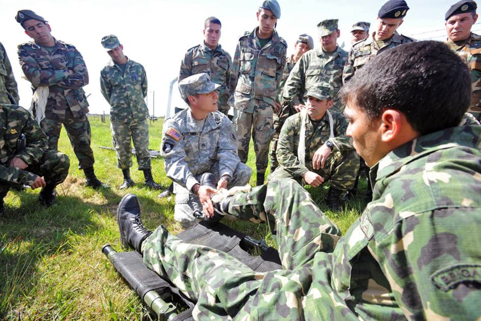Staff Sgt. Robert Hogeland (center), the clinical operations NCO in charge at U.S. Army South’s medical directorate, demonstrates various ways to stabilize a fractured ankle to members of the Uruguayan military during a tactical Combat Lifesaver Course subject matter expert exchange in September 2014 outside of Montevideo, Uruguay.
Photo by Robert Ramon