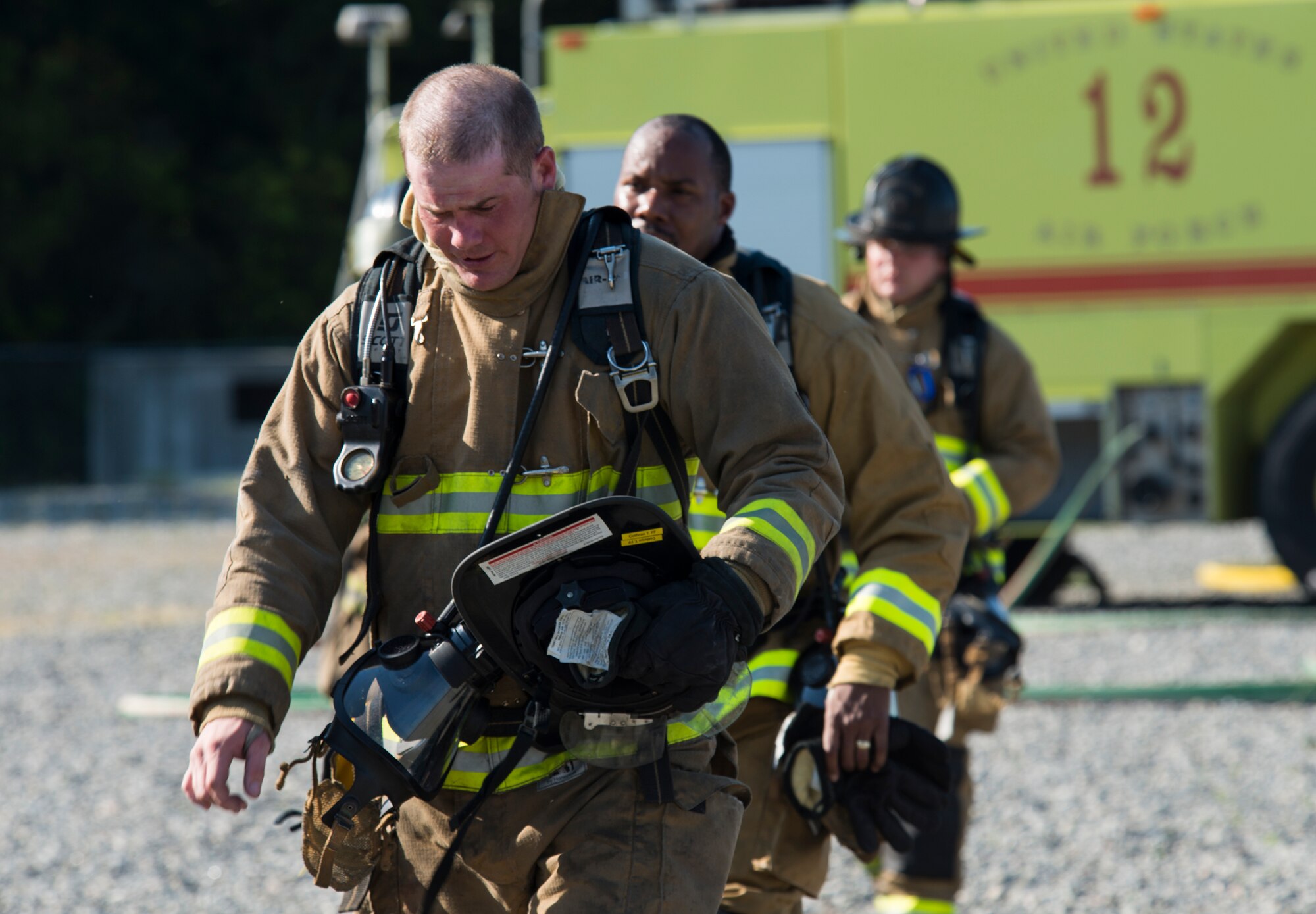 Travis Detweiler, front, and Sgt. Jordan Washington, Valdosta Fire Department firefighters, wrap up the joint aircraft fire training April 8, 2015, at Moody Air Force Base, Ga. Approximately 13 VFD firefighters participated in the joint training to complete their annual Federal Aviation Administration certification requirements. (U.S. Air Force photo by Airman 1st Class Ceaira Tinsley/Released)