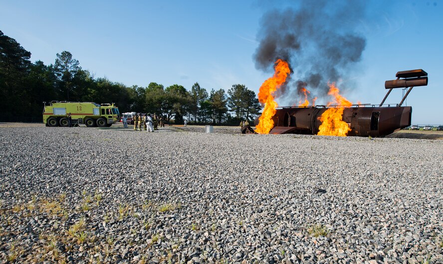 Firefighters from the 23d Civil Engineer Squadron and the Valdosta Fire Department, wait for the signal to begin joint aircraft fire training April 8, 2015, at Moody Air Force Base, Ga. The two fire departments train together annually and the training completes VFD’s annual certification requirements. (U.S. Air Force photo by Airman 1st Class Ceaira Tinsley/Released)