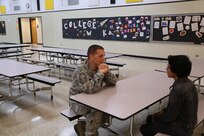 Master Sgt. Joseph Larouche, Air Education and Training Command munitions program manager, talks with Daniel, a student in eighth grade at Dobie Junior High School April 1 in Cibolo, Texas during a weekly mentoring session as part of the Communities in Schools of South Central Texas program. (U.S. Air Force photo by Airman 1st Class Alexandria Slade)
