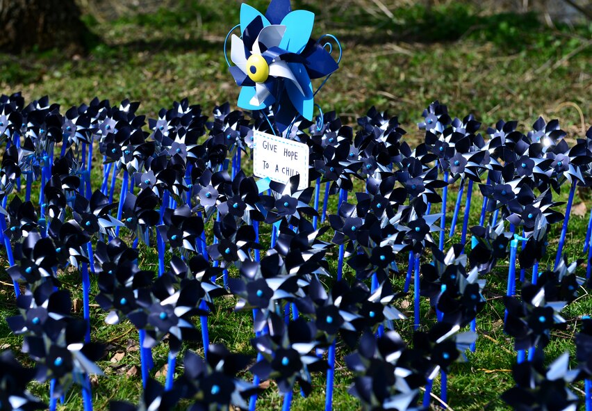 Blue and silver pinwheels were placed near the duck pond on Royal Air Force Lakenheath, England, April 10, 2015 to designate reports of child abuse from the past three years. For every pinwheel placed around the pond, two reports of child abuse are represented. (U.S. Air Force photo by Airman 1st Class Dawn M. Weber/Released)