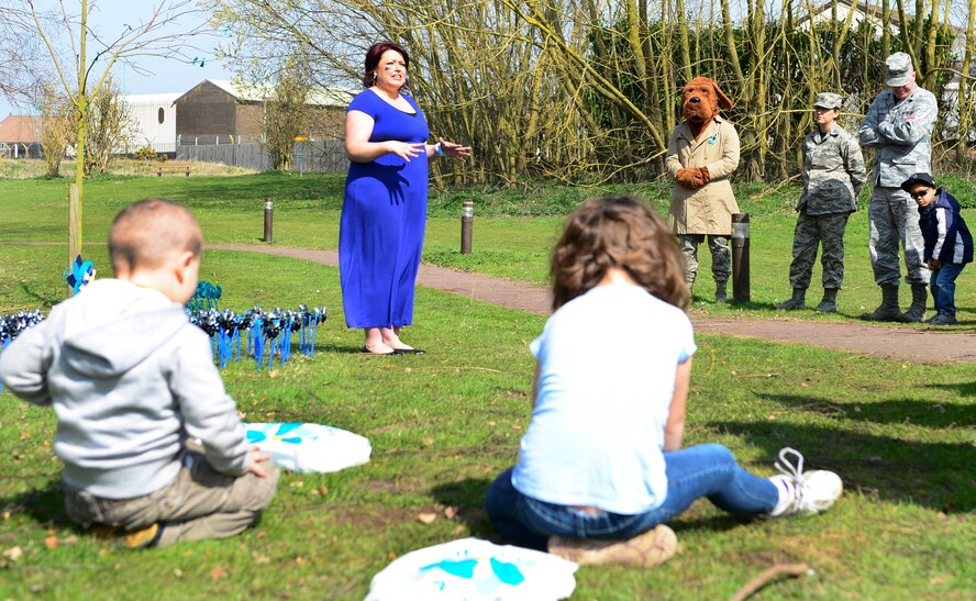 Carolina Yepez, 48th Fighter Wing Sexual Assault Response Coordinator, speaks to an audience at the duck pond on Royal Air Force Lakenheath, England, April 10, 2015. The Sexual Assault Prevention and Response and Family Advocacy offices hosted Pinwheels in the Park to honor survivors of sexual assault and child abuse. (U.S. Air Force photo by Airman 1st Class Dawn M. Weber/Released)