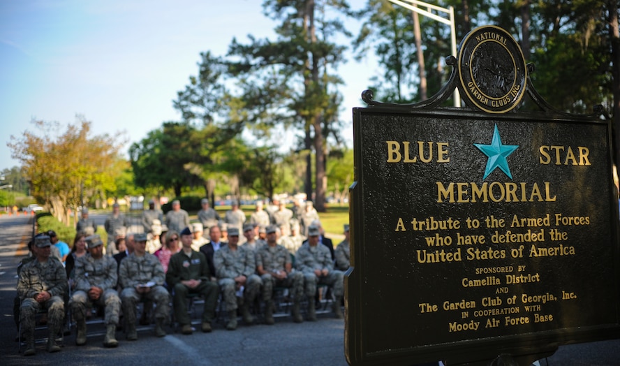 Audience members listen during the Blue Star Memorial Marker Dedication ceremony April 7, 2015 at Moody AFB, Ga. The blue star on the marker dates back to WWII, when churches and families would hang flags and banners with the star to honor their sons and daughters who were away at war. (U.S. Air Force photo by Andrea Jenkins/Released)