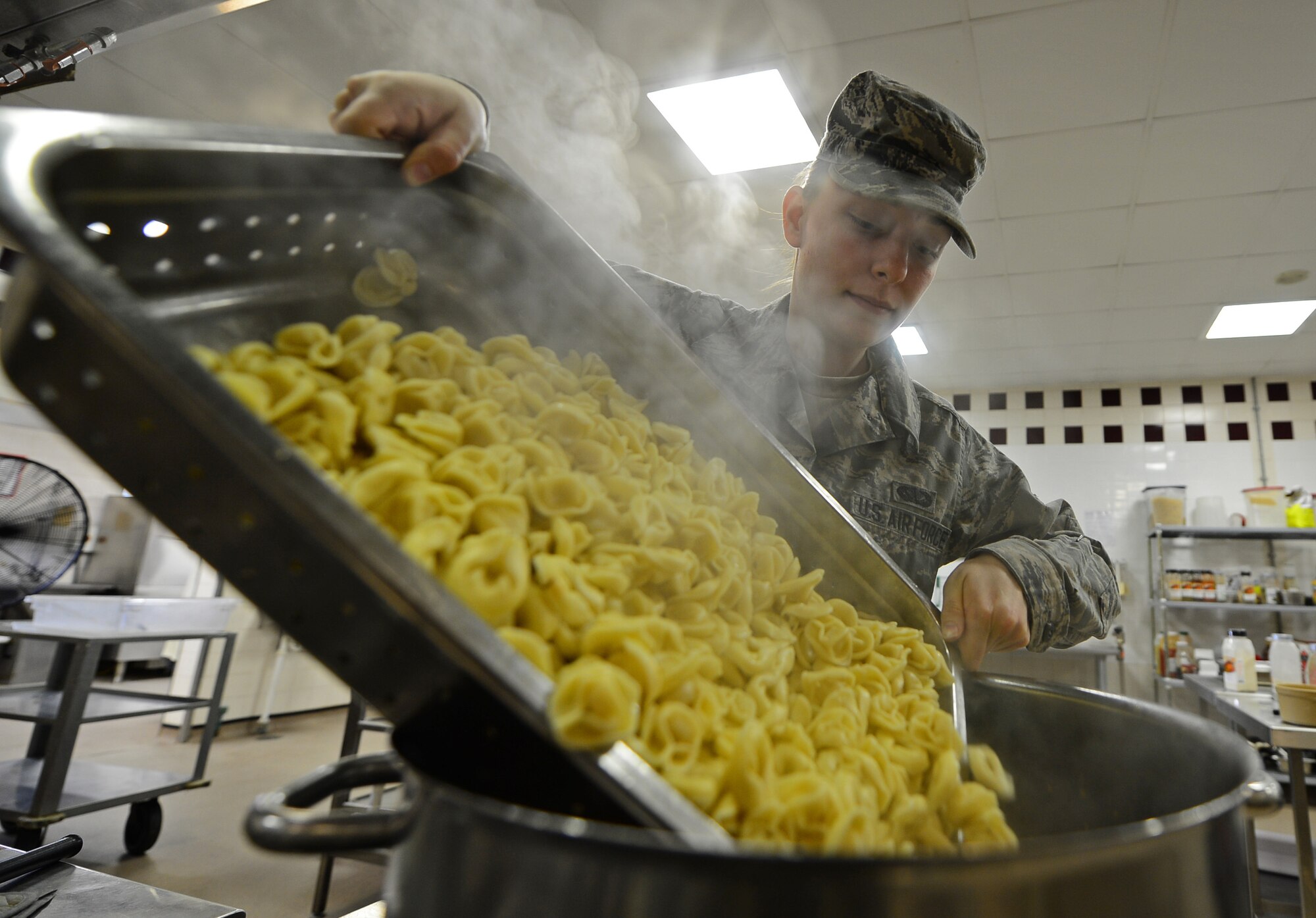 Airman 1st Class Alexandria Young, 48th Force Support Squadron food service technician, prepares a pasta dish for lunch at the Knight’s Table dining facility at Royal Air Force Lakenheath, England, April 10, 2015. Young was nominated for a Liberty Spotlight because she embodies the core value of Service Before Self. (U.S. Air Force photo by Airman 1st Class Erin R. Babis/Released)