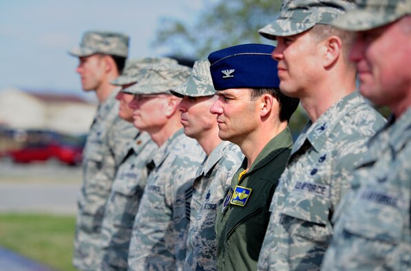 Col. David Benson, 509th Operations Group commander, stands at attention during a wing retreat ceremony at Whiteman Air Force Base, Mo., March 27, 2015. A retreat ceremony signifies the end of a duty day and is also a way to pay tribute to the American flag. (U.S. Air Force photo by Staff Sgt. Nick Wilson/Released)